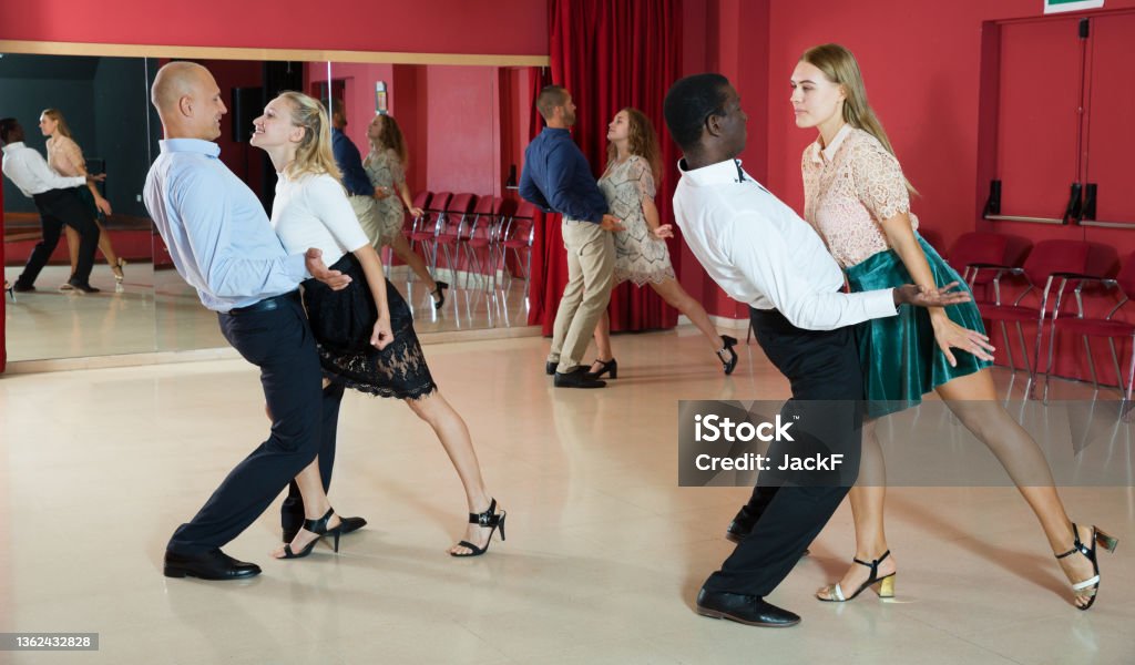 People dancing rock-and-roll in pairs Young positive people dancing rock-and-roll in pairs 20-24 Years Stock Photo