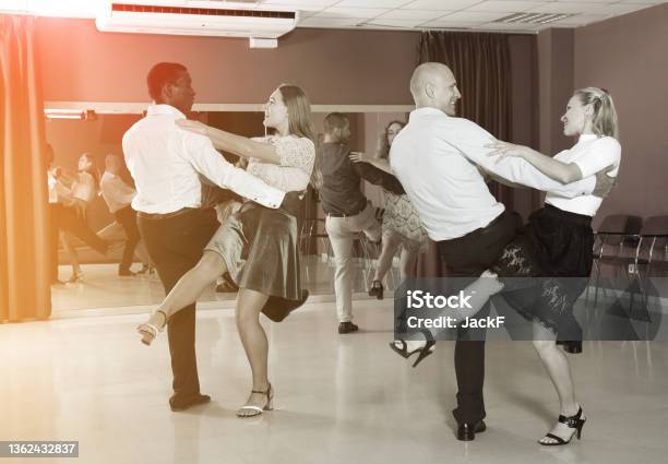 Couples Enjoying Boogiewoogie Stock Photo - Download Image Now - Swing Dancing, Adult, 20-24 Years