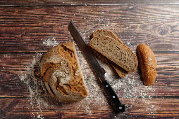istock A round loaf of a crusty bread, on a rustic wooden table. 1362435950