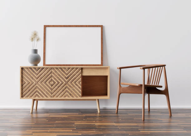 istock Empty picture frame on white wall in modern living room. Mock up interior in scandinavian style. Free space, copy space for your picture. Wooden console and armchair. 3D rendering. 1362437696