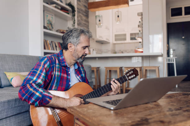 istock Mature man having a guitar class online 1362441252