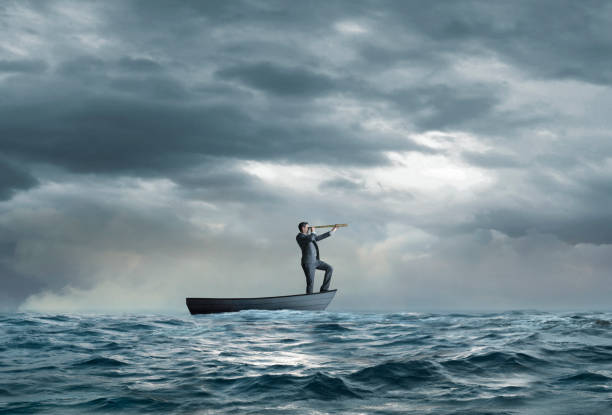 istock Stranded Businessman In Row Boat Searches For Help 1362444865