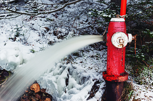 A fire hydrant is left open in Winter to relieve pressure.