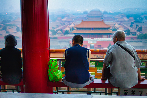 Beijing, China - July 18 2010 : the sky is polluted with smog abobe the main landmark the forbidden city while these people are looking at it