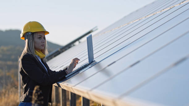 istock Female engineer working in solar power plant. Renewable energy systems. Solar city. 1362449180