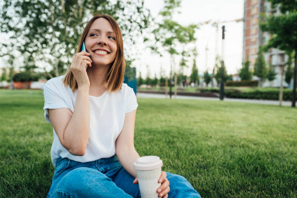 istock Girl enjoying coffee from a reusable cup in the park 1362449264
