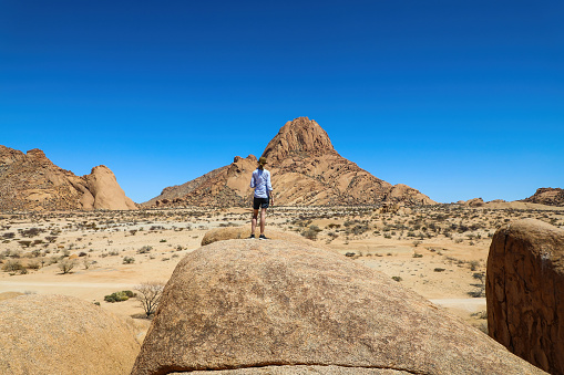 Female hiker enjoying the dramatic rock landscape of Spitzkoppe Namibia