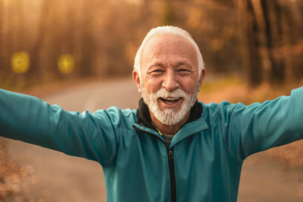 istock Happy senior man celebrating life outdoors in nature. 1362455908