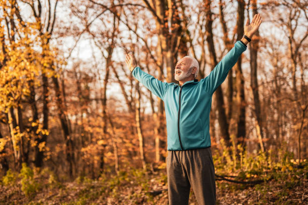 istock Happy senior man celebrating life outdoors in nature. 1362455972