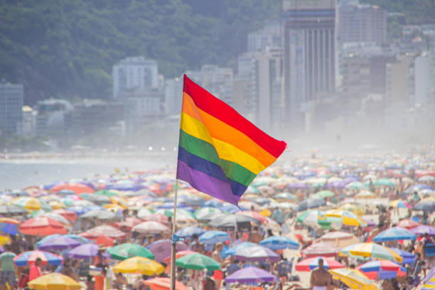 rainbow flag of the LGBT movement at Ipanema beach in Rio de Janeiro - Brazil. stock photo