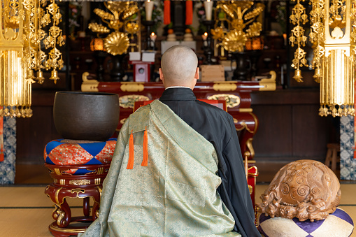 Image material of a monk praying at a Buddhist altar