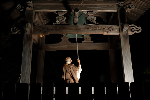 A monk ringing a bell to celebrate the new year