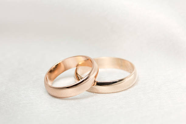 istock Two  weddings rings on white  fabric 136246324