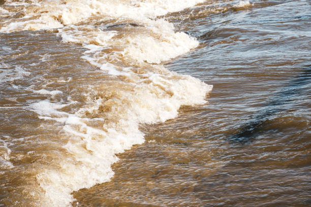 istock Stream of dirty meltwater on sunny spring day. 1362473932