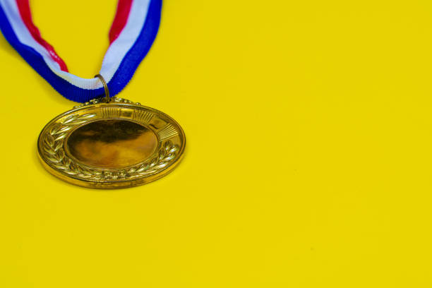 istock Mulitple gold medal mockup on yellow trending background with copyspace or text flat lay. 1362474244