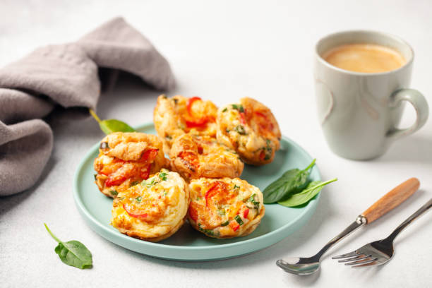 istock Egg muffins ( bites) and spinach leaves  in a plate on a gray background 1362478910