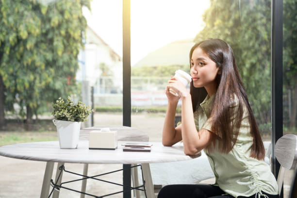 istock Asian woman holding coffee 1362485704