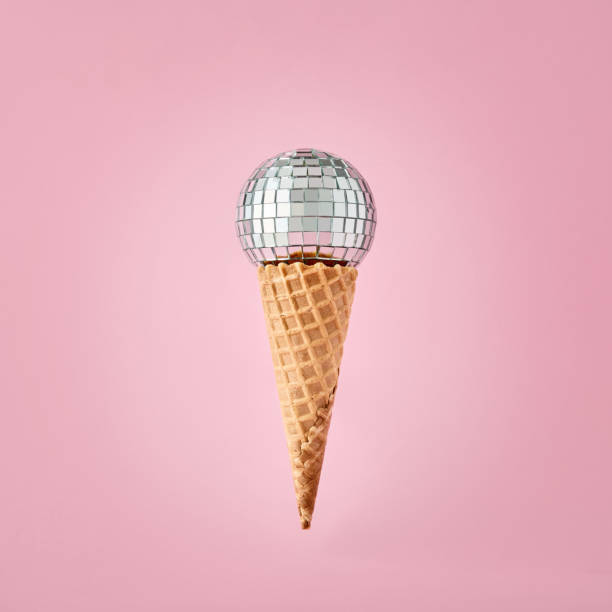 istock Disco ball on ice cream cone on pink background. Party and fun. 1362488825