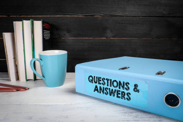 istock Questions and Answers. Document folder, binder on office desk 1362494299