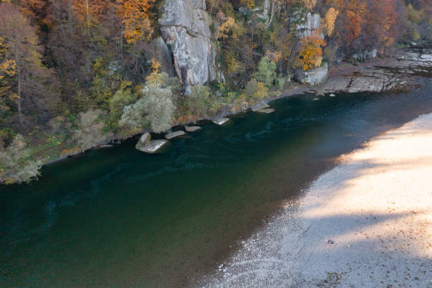 istock Shallow mountain river at foothill with terracotta forests 1362495203