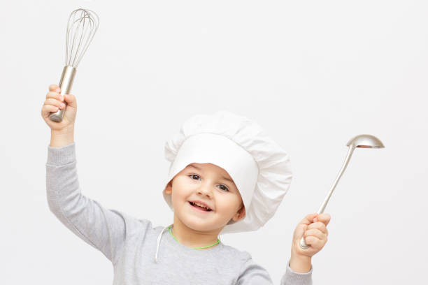 istock Happy little chef with a whisk, on white background. 1362495416