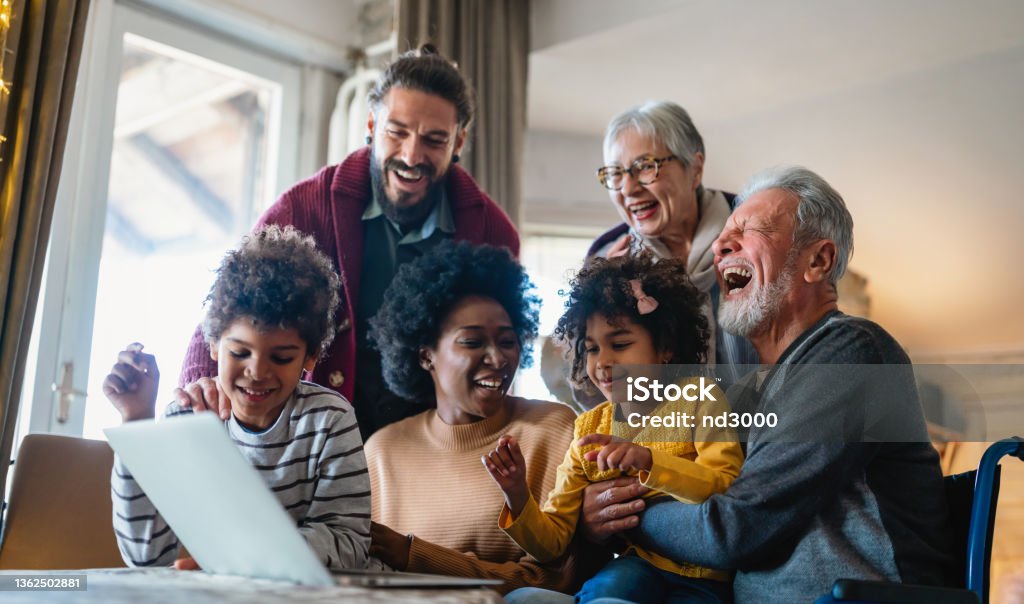 Portrait of a happy multigenerational multiethnic family at home. Portrait of a happy multigenerational multiethnic family at home. People group technology love concept Family Stock Photo