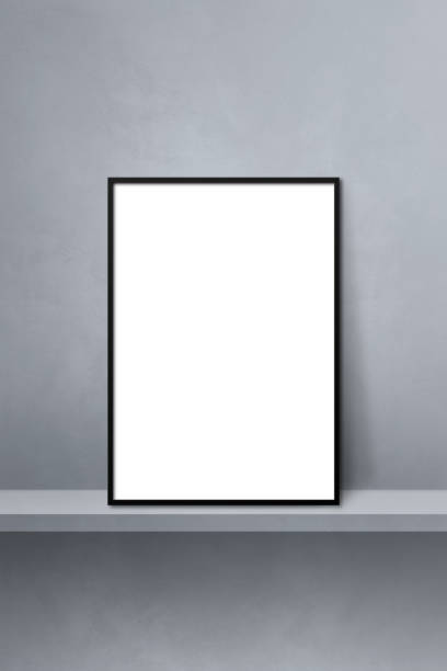 istock Black picture frame leaning on a grey shelf. 3d illustration. Vertical background 1362505759