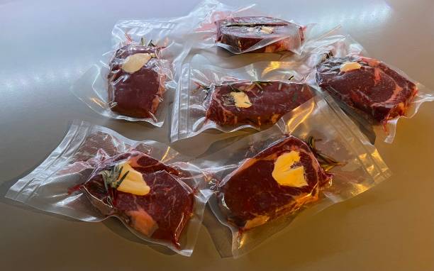 Lunch Dinner - Beef Steaks with Butter and Rosemary in Vacuum Bag for Sous Vide stock photo