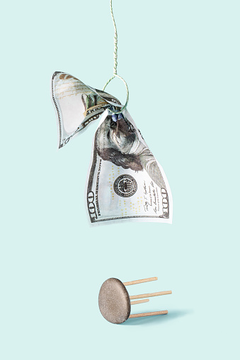 One hundred dollar bill was hanged. Financial crisis, inflation, default concept on light green background. Still life