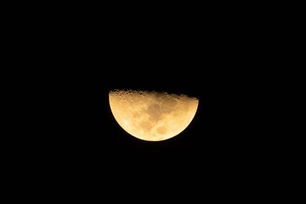 istock The half moon, luna at night isolated on black background. Nature 1362511662