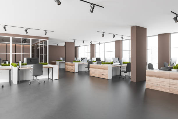 istock Dark open space interior with armchairs and pc on concrete floor, windows 1362511918