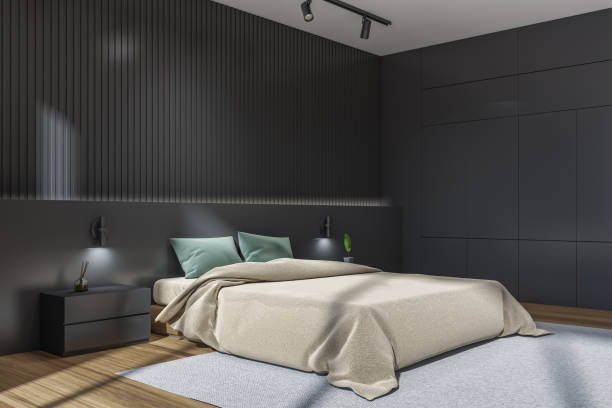 istock Dark bedroom interior with bed on carpet, nightstand with decoration 1362514089