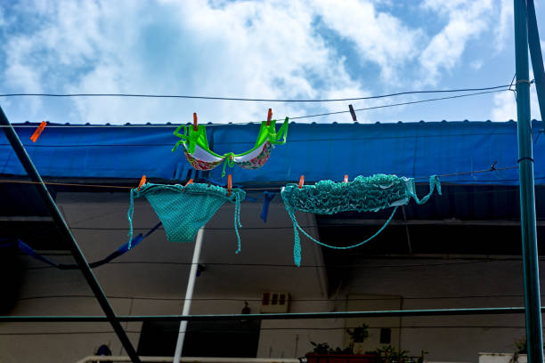 istock Female swimsuit drying outdoors against the sky 1362514833