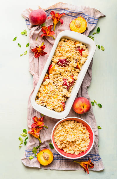istock Peaches with baking pan and shortbread dough on light background, top view. 1362517405