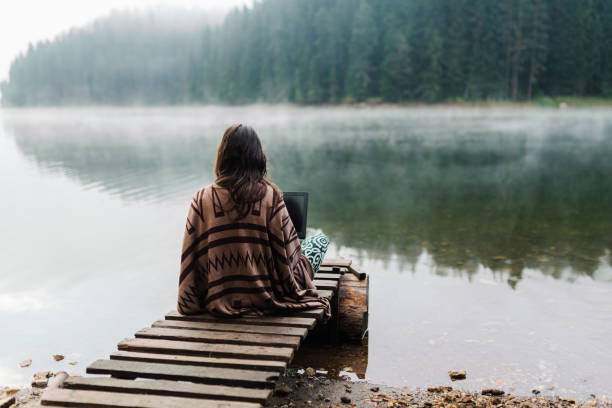 istock Woman Relaxing In Nature And Using Technology 1362517563