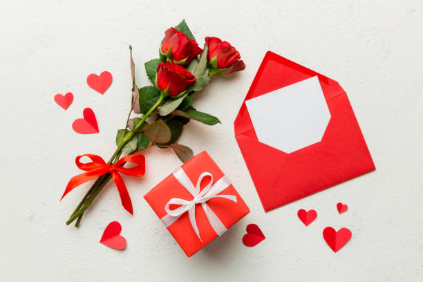 istock Valentine day composition with Envelope, rose flower and Red heart on table. Top view, flat lay. Holiday concept 1362517582
