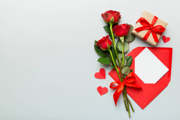 istock Valentine day composition with Envelope, rose flower and Red heart on table. Top view, flat lay. Holiday concept 1362517584