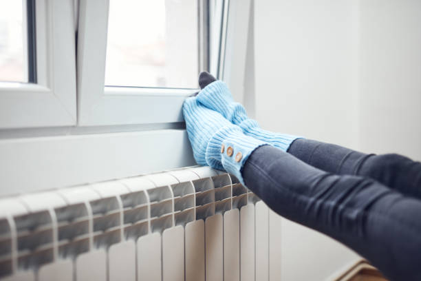 istock Woman's feet with woolen socks, enjoying inside home on the radiator. 1362518832