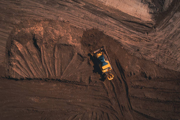 istock Yellow tracked bulldozer performs earthworks - aerial view shot 1362519042