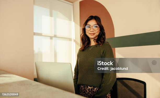 Cheerful Receptionist Standing At The Front Desk Stock Photo - Download Image Now - Hotel Reception, Receptionist, Reception Desk