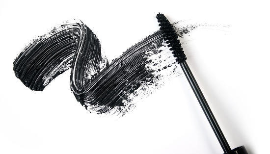 A smear of black eye liner from a mascara brush
