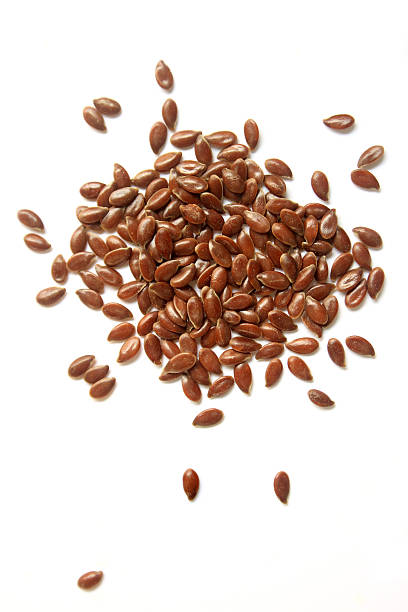 Brown flax seeds on a white background Flax seeds on White Background. flax seed stock pictures, royalty-free photos & images