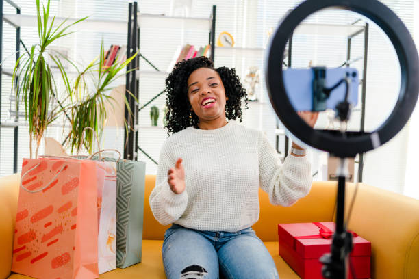 Smiling African influencer doing a vlog post in her living room