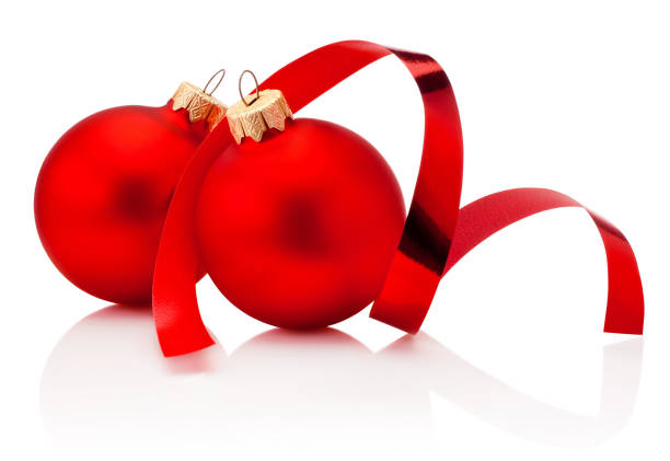 istock Two red Christmas baubles and curling paper Isolated on white background 1362529018