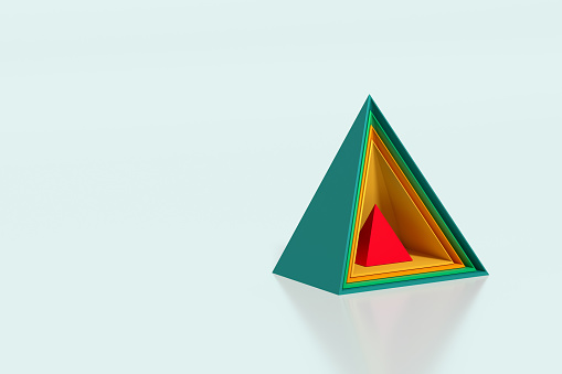 Intertwined pyramids one of them is red on a green background with copy space, safety concept,  3D - Computer generated image.