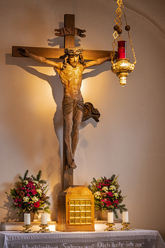 Old crucifix made of wood in the Heilig-Geist-Kirche, Church of the Holy Spirit which is standing in the center of the German city Munich is one of the oldest churches in Munich but was remodeled in 1730 and 1885. Today it is partly a reconstruction made after second world war.