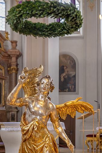 Gold plated angel with a Christmas decoration in the Heilig-Geist-Kirche, Church of the Holy Spirit which is standing in the center of the German city Munich is one of the oldest churches in Munich but was remodeled in 1730 and 1885. Today it is partly a reconstruction made after second world war.