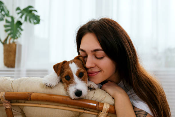 istock Young brunette woman with small breed dog. 1362532985