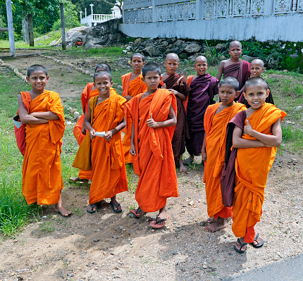 Lessons over. Buddhist novices gather at the roadside, near Yala, Sri Lanka, South Asia. Sri Lanka, formerly Ceylon, is a  beautiful warm tropical island off the south eastern coast of India with a rich history of Sinhalese kingdoms and a mixture of faiths including Hindu Buddhist and Tamil as well as Dutch and British colonial influences. It has a wealth of birdlife and wildlife including many endangered wild animals.