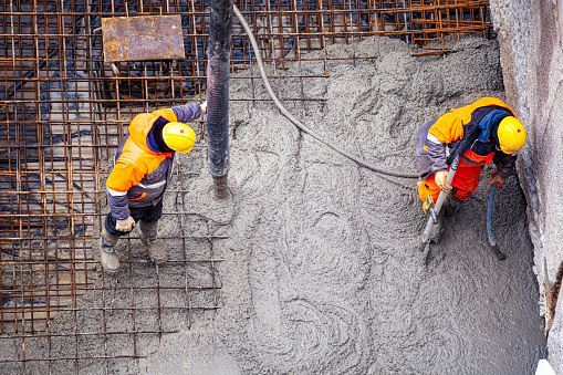 Workers pouring concrete. Concrete pouring on the construction site